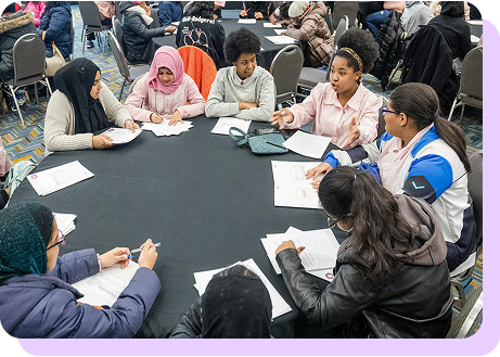 a group of students conversing during a workshop